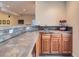 Basement wet bar area with tiled counters, cabinets, and sink at 11074 Grayledge Cir, Highlands Ranch, CO 80130