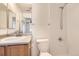 Clean bathroom with shower, toilet and vanity with wood cabinet at 5833 N Biscay St, Denver, CO 80249