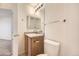 Small bathroom with toilet and vanity with wood cabinet at 5833 N Biscay St, Denver, CO 80249