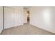 Bright bedroom with carpet, double doors and hallway view at 5833 N Biscay St, Denver, CO 80249