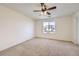 Bright bedroom with carpet flooring, ceiling fan, and large window at 5833 N Biscay St, Denver, CO 80249
