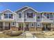 Gray townhome with brick accents and a charming front porch at 5833 N Biscay St, Denver, CO 80249