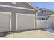 Two-car garage with attached driveway and fence at 5833 N Biscay St, Denver, CO 80249