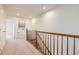 Upper hallway with carpet, leading to laundry and bedrooms at 5833 N Biscay St, Denver, CO 80249