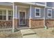 Inviting house entrance with brick accents and a security door at 5833 N Biscay St, Denver, CO 80249