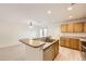 Open kitchen with island and breakfast bar at 5833 N Biscay St, Denver, CO 80249