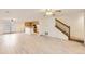 Open living room and kitchen with light hardwood floors at 5833 N Biscay St, Denver, CO 80249