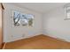 Empty bedroom with a large window and hardwood floors providing plenty of natural light at 1420 E Bates Ave, Englewood, CO 80113