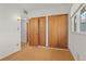 Bedroom view featuring closet doors, and an adjacent bathroom door at 1420 E Bates Ave, Englewood, CO 80113