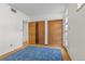 Bedroom features natural light, wood closet doors, and neutral flooring at 1420 E Bates Ave, Englewood, CO 80113