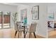 Bright dining space with a glass table, neutral chairs, and natural light from the sliding glass doors at 1420 E Bates Ave, Englewood, CO 80113
