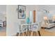 Chic dining area with a glass-top table, comfortable seating, and view to the living room at 1420 E Bates Ave, Englewood, CO 80113