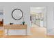Welcoming entryway showcasing a stylish console table, elegant mirror, and a glimpse into the bright kitchen at 1420 E Bates Ave, Englewood, CO 80113