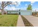 Charming home exterior with well-maintained lawn and blossoming flower beds at 1420 E Bates Ave, Englewood, CO 80113