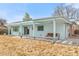 Back exterior view of home with covered patio and spacious yard at 1420 E Bates Ave, Englewood, CO 80113