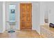 Foyer features a wood door, tile floor, and a side window for natural light at 1420 E Bates Ave, Englewood, CO 80113