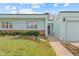 Well-maintained exterior of single story home with vibrant green lawn and manicured flower beds at 1420 E Bates Ave, Englewood, CO 80113