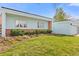 Charming single story home exterior with a lush green lawn and beautiful garden beds at 1420 E Bates Ave, Englewood, CO 80113