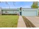 Charming single story home with a manicured lawn and flower beds along the walkway to the front door at 1420 E Bates Ave, Englewood, CO 80113