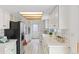 Functional kitchen with white tile flooring, ample counter space, and stainless steel appliances, bright and clean at 1420 E Bates Ave, Englewood, CO 80113