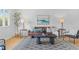 Comfortable living room with a cozy leather sofa, stylish decor, and accent lighting on side tables at 1420 E Bates Ave, Englewood, CO 80113