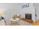 Stylish living room features a white brick wall, fireplace, and neutral-toned decor, creating a warm ambiance at 1420 E Bates Ave, Englewood, CO 80113
