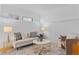 Inviting living room with a white brick accent wall, modern furniture, and stylish decor, filled with light at 1420 E Bates Ave, Englewood, CO 80113