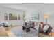 Inviting living room featuring a brown leather sofa, modern art, and large window with natural light at 1420 E Bates Ave, Englewood, CO 80113