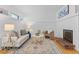 Bright living room featuring white brick walls, modern decor, and cozy fireplace, bathed in natural light at 1420 E Bates Ave, Englewood, CO 80113