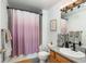 Bathroom featuring a shower with a curtain, toilet, and vanity with modern fixtures at 3242 E 103Rd Dr # 602, Thornton, CO 80229