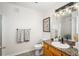 Bathroom with granite-topped vanity, toilet, and shower with glass doors at 3242 E 103Rd Dr # 602, Thornton, CO 80229