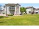 Beautifully landscaped exterior showcases a well-manicured lawn, stone accents, and inviting balconies for outdoor enjoyment at 3242 E 103Rd Dr # 602, Thornton, CO 80229