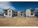 Exterior view of multiple townhouses with balconies, stone accents and lawn area at 3242 E 103Rd Dr # 602, Thornton, CO 80229