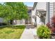 Charming home featuring a well-maintained lawn, stone accents, and a welcoming walkway leading to the front entrance at 3242 E 103Rd Dr # 602, Thornton, CO 80229
