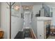 Hallway boasting hardwood floors, neutral paint, and a cozy fireplace at 3242 E 103Rd Dr # 602, Thornton, CO 80229