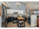 Modern kitchen featuring stainless steel appliances, dual colored cabinets, and a kitchen island at 3242 E 103Rd Dr # 602, Thornton, CO 80229