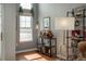 Bright living area featuring a bar cart, window, bookshelf, and stylish furnishings at 3242 E 103Rd Dr # 602, Thornton, CO 80229