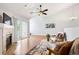 Bright living room with fireplace, ceiling fan, and sliding door access to the balcony at 3242 E 103Rd Dr # 602, Thornton, CO 80229