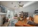 Inviting living room featuring vaulted ceilings, a fireplace, leather sofa and chair set, and a patio door at 3242 E 103Rd Dr # 602, Thornton, CO 80229