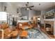 Inviting living room featuring a cozy leather couch, fireplace, and a stylish ceiling fan at 3242 E 103Rd Dr # 602, Thornton, CO 80229