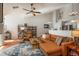 Cozy living room featuring a stylish leather couch, hardwood floors, and a ceiling fan at 3242 E 103Rd Dr # 602, Thornton, CO 80229