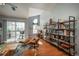 Bright living room featuring hardwood floors, large windows, and a stylish bookshelf at 3242 E 103Rd Dr # 602, Thornton, CO 80229