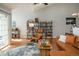 Inviting living room with leather furnishings, bookshelf, and a large sliding glass door to the outdoor space at 3242 E 103Rd Dr # 602, Thornton, CO 80229