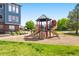 Community playground with slides, climbing structures, and a safe play area for children, nestled in a green space at 3242 E 103Rd Dr # 602, Thornton, CO 80229