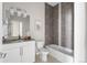 Well lit bathroom featuring a modern vanity, toilet and a tiled bathtub and shower combo at 2733 W 28Th Ave # 6, Denver, CO 80211