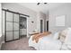 Inviting bedroom featuring a sliding barn door to bathroom, soft carpeting, and bright natural light at 2733 W 28Th Ave # 6, Denver, CO 80211