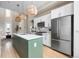 Bright kitchen featuring stainless steel appliances and a center island with a marble countertop at 2733 W 28Th Ave # 6, Denver, CO 80211