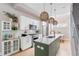 Bright kitchen boasts white cabinets, stainless steel appliances, an island with marble countertops and unique, decorative lighting at 2733 W 28Th Ave # 6, Denver, CO 80211