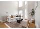 Spacious living room with soaring ceilings, ample natural light, comfortable seating, and stylish decor at 2733 W 28Th Ave # 6, Denver, CO 80211