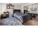 Comfortable bedroom with a large bed, mirrored closet doors, and decorative wall shelves at 6755 S Ivy St # A7, Centennial, CO 80112